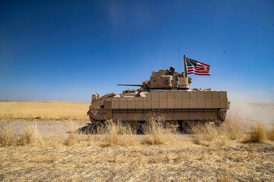 US soldiers in a Bradley Fighting Vehicle patrol the countryside in Syria's northeastern Hasakah province.