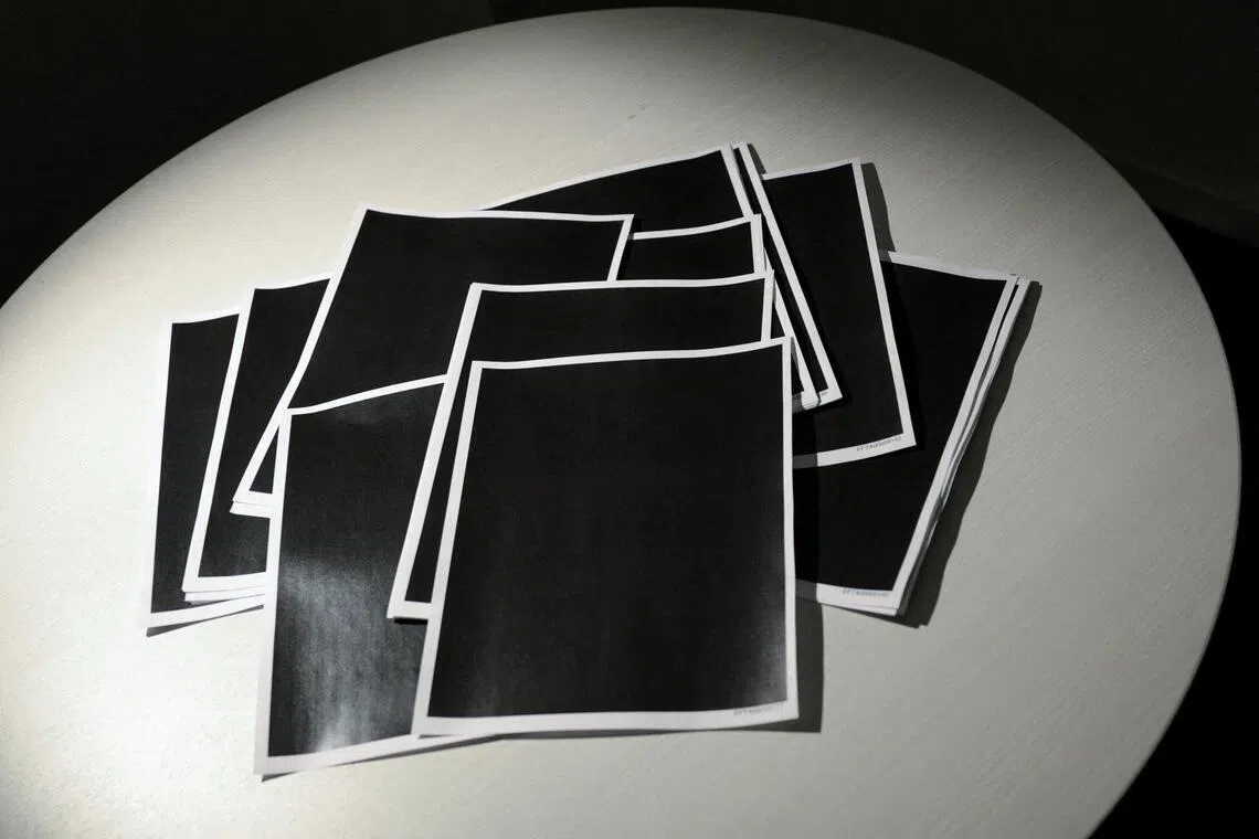 Printed copies of newly-released documents from cases against disgraced late financier and sex offender Jeffrey Epstein - including entirely redacted pages.