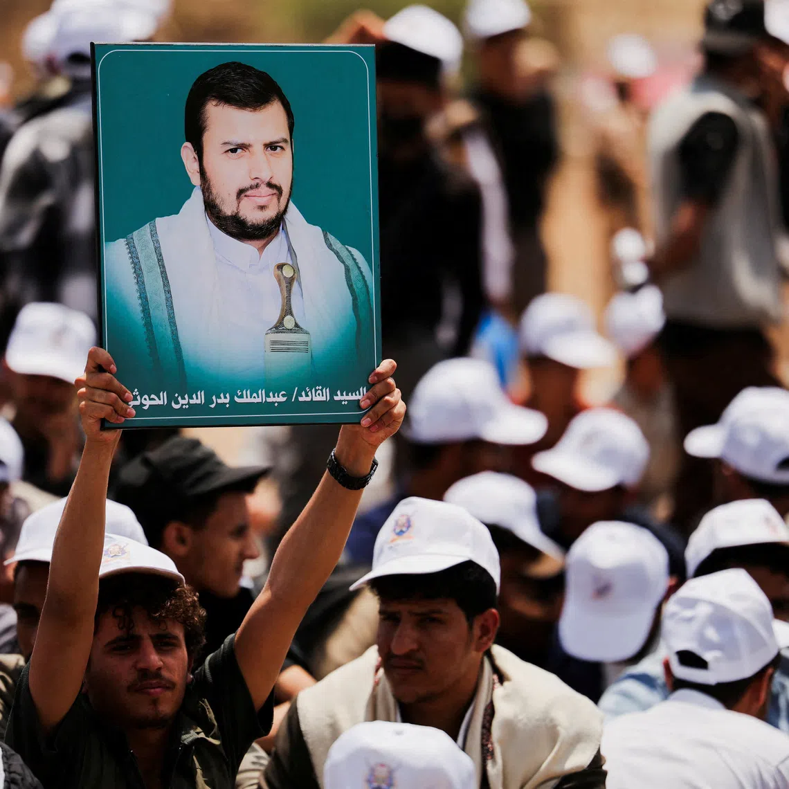 FILE PHOTO: A student holds up a poster of Houthi leader Abdul-Malik al-Houthi during a parade at Sanaa University campus to show support for the Houthis amid an escalation with Saudi Arabia, in Sanaa, Yemen July 22, 2026. REUTERS/Khaled Abdullah/File Photo