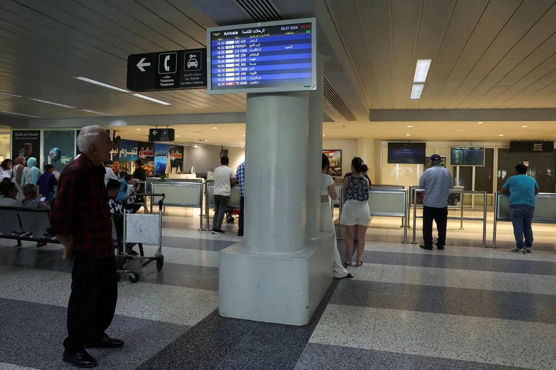 A man checks a flight information board showing a cancelled flight at the Beirut–Rafic Hariri International Airport, in Beirut, Lebanon July 29, 2024. REUTERS/Emilie Madi