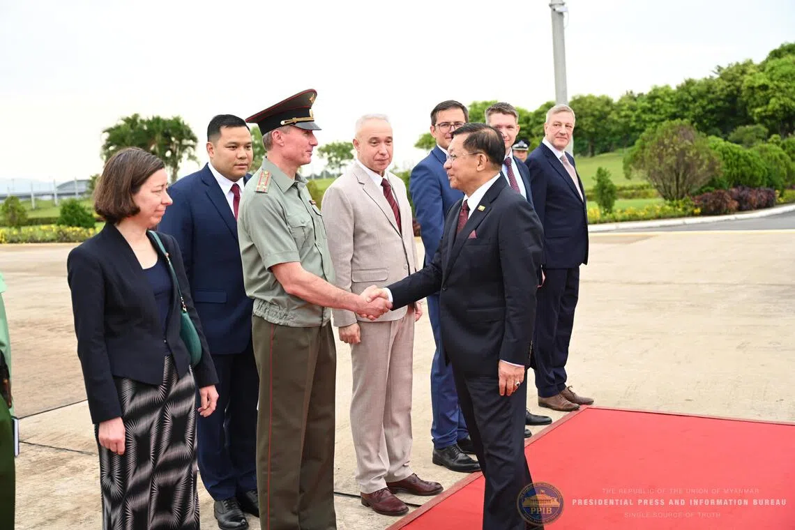 Myanmar President Min Aung Hlaing greeting a foreign military attache as he departs for Russia, at the Naypyitaw International Airport in Myanmar on Aug 17.