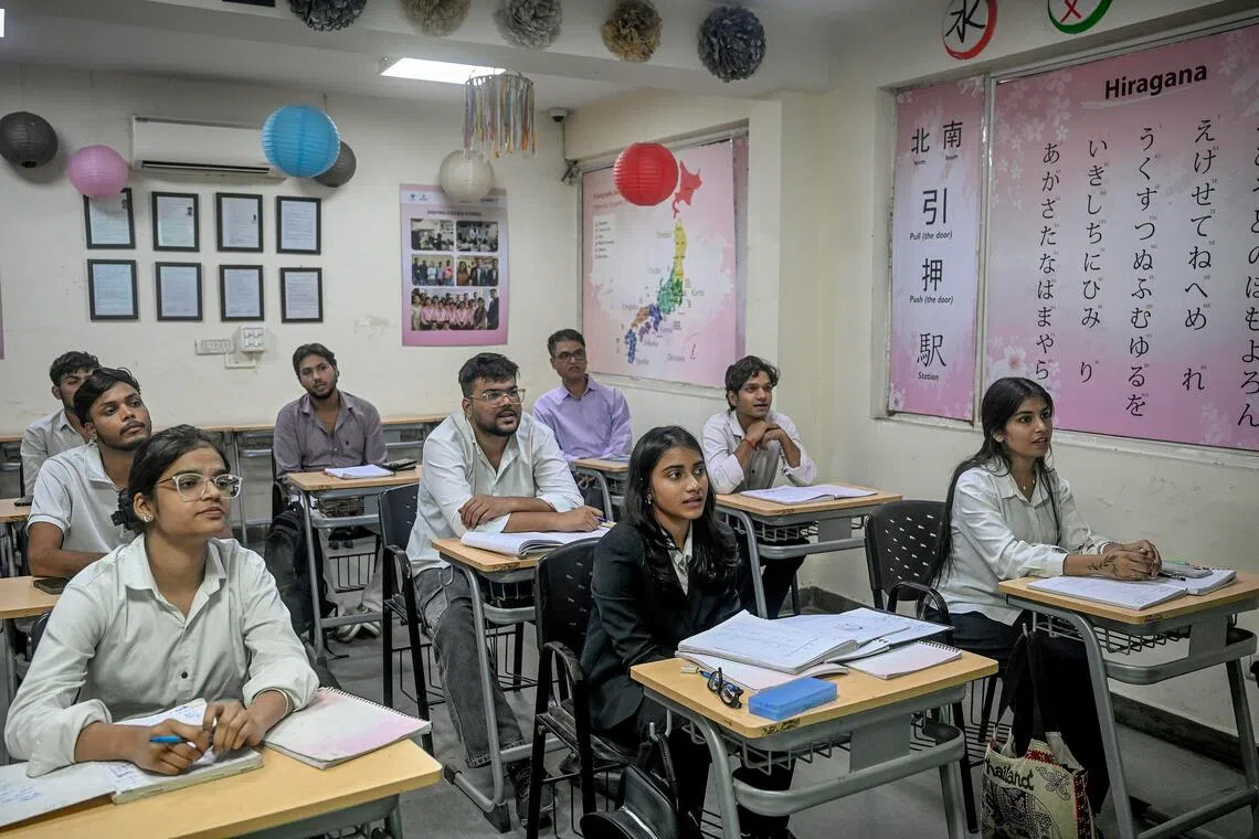 Students hoping to work in Japan study Japanese at a language school in New Delhi.