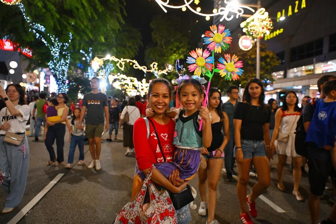Ms Bernadette Neo, 39, a secretary, with her daughter Isabella Neo, aged seven, at the Great Christmas Eve Party on Dec 24.