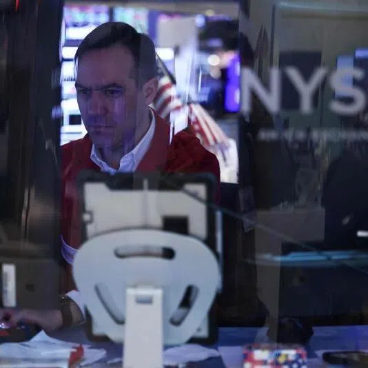 A trader works on the floor of the New York Stock Exchange at the opening bell in New York City on April 7, 2026. 