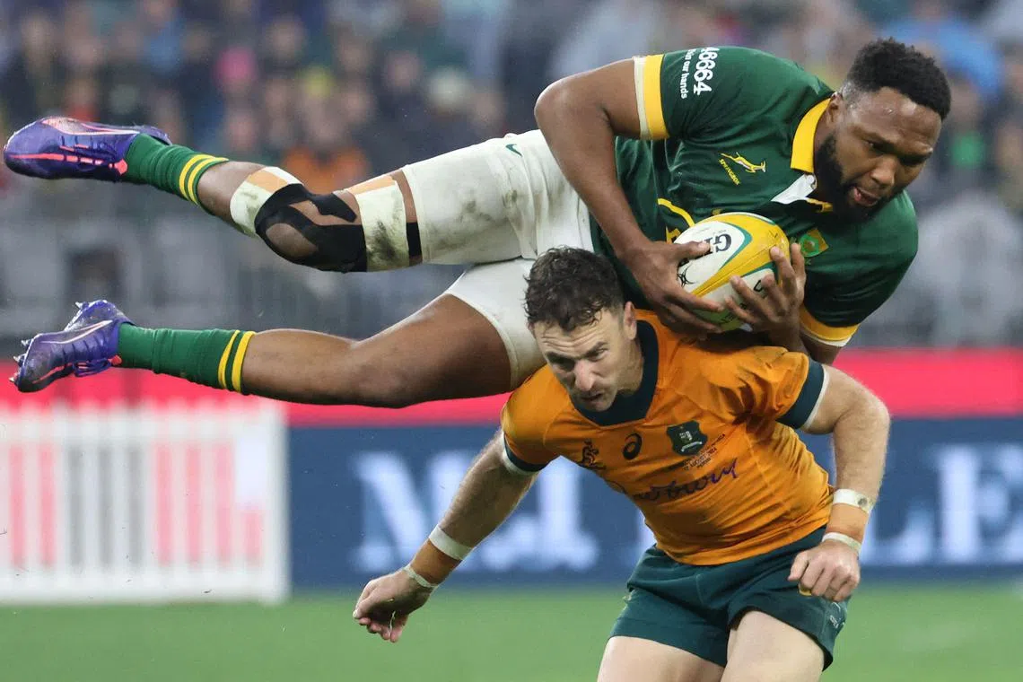 South Africa's Lukhanyo Am gets on top of Australia's Nic White to win the ball in their Rugby Championship Test match at Optus Stadium in Perth on Aug 17, 2024.