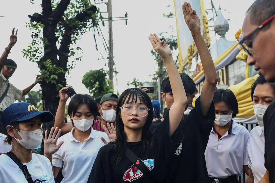 Thai monarchy reform activist Tantawan "Tawan" Tuatulanon shows a three-finger salute as she is arrested for sedition and related charges outside a criminal court in Bangkok, Thailand, February 13, 2024. REUTERS/Chalinee Thirasupa