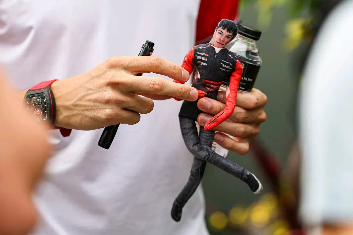 MoneyGram Haas' Esteban Ocon holding a plushie of fellow driver Oliver Bearman at the paddock entrance ahead of the final practice session of the 2025 Formula One Singapore Airlines Singapore Grand Prix at the Marina Bay Street Circuit on Oct 4, 2025. 