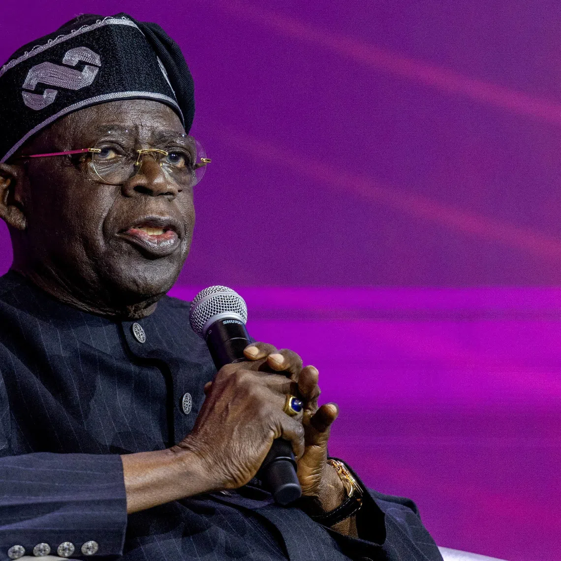 FILE PHOTO: Nigeria's president Bola Tinubu attends a panel discussion during the Africa CEO forum under the theme “The Scale Imperative: Why Africa Must Embrace Shared Ownership,” at the Kigali Convention Centre in Kigali, Rwanda, May 14, 2026. REUTERS/Jean Bizimana/File Photo