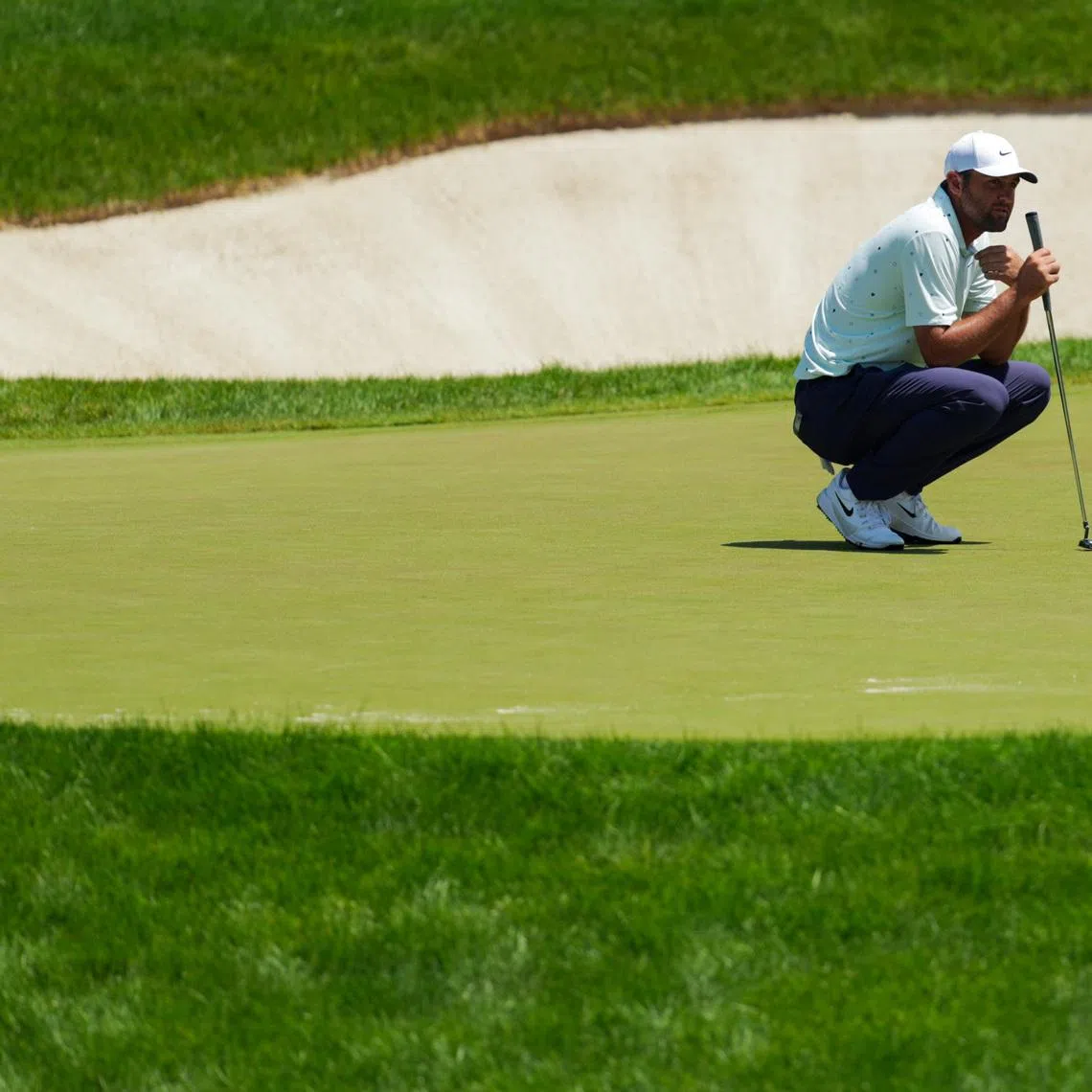 Jun 5, 2026; Dublin, Ohio, USA; Scottie Scheffler lines up a putt on the 18th green during the second round of the Memorial Tournament presented by Workday golf tournament. Mandatory Credit: Aaron Doster-Imagn Images