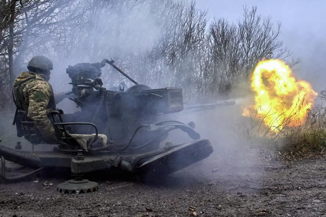 epa10300717 A member of Ukraine's National Guard fires an anti-aircraft gun at a position not far from Kharkiv, northeastern Ukraine, 11 November 2022, amid Russia's invasion. Kharkiv and surrounding areas have been the target of heavy shelling since February 2022, when Russian troops entered Ukraine starting a conflict that has provoked destruction and a humanitarian crisis. At the beginning of September, the Ukrainian army pushed Russian forces from occupied territory in the northeast of the country in counterattacks.  EPA-EFE/SERGEY KOZLOV