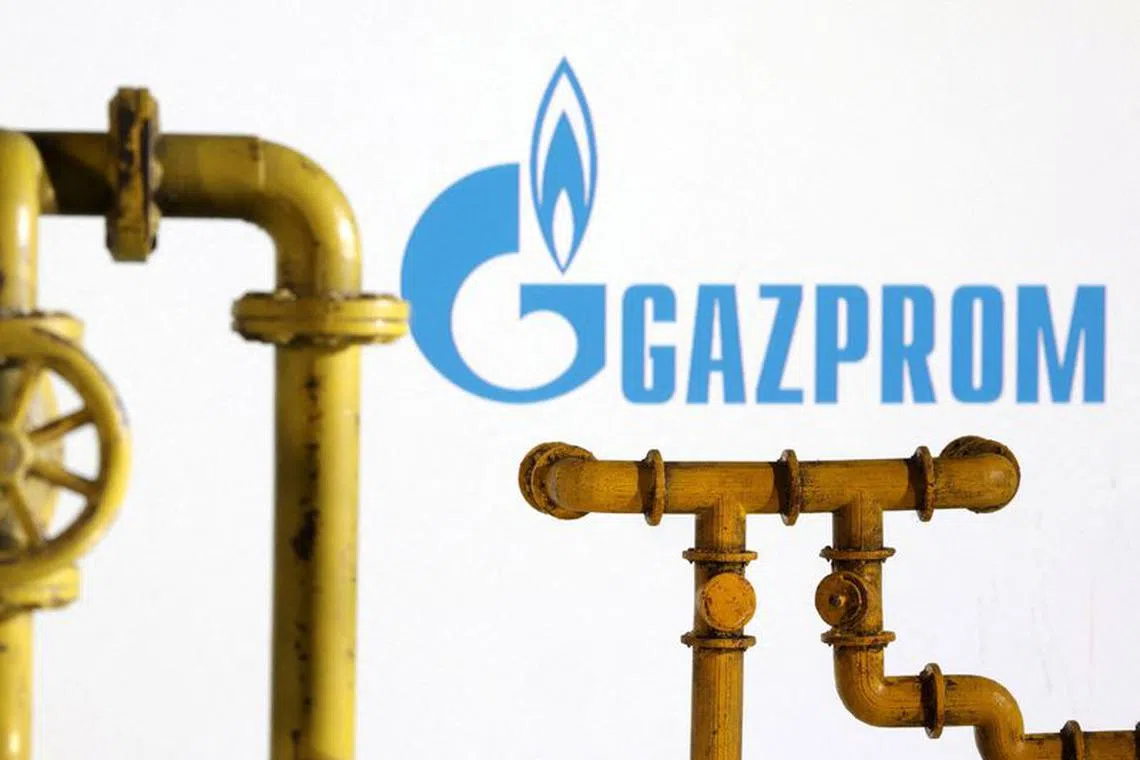 FILE PHOTO: Model of natural gas pipeline and Gazprom logo, July 18, 2022. REUTERS/Dado Ruvic/Illustration/File Photo