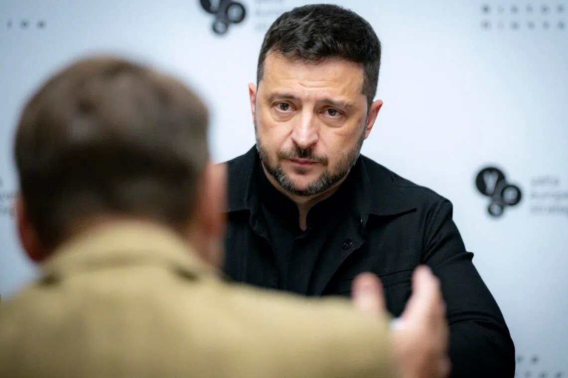 A Russia-backed website mimicking Britain's Daily Telegraph newspaper claimed Ukrainian President Volodymyr Zelensky (right) had embezzled money for an offshore property empire.