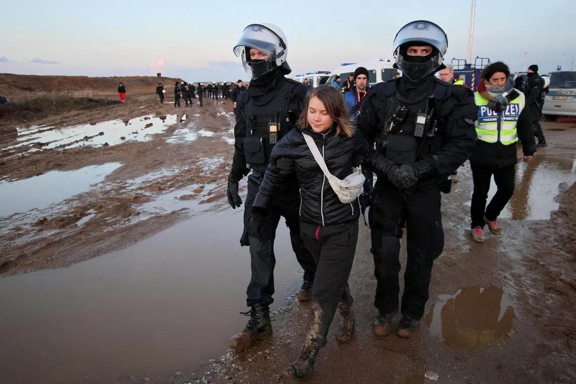 Police officers detain climate activist Greta Thunberg on the day of a protest against the expansion of the Garzweiler open-cast lignite mine of Germany's utility RWE to Luetzerath, in Germany, January 17, 2023 that has highlighted tensions over Germany's climate policy during an energy crisis. 