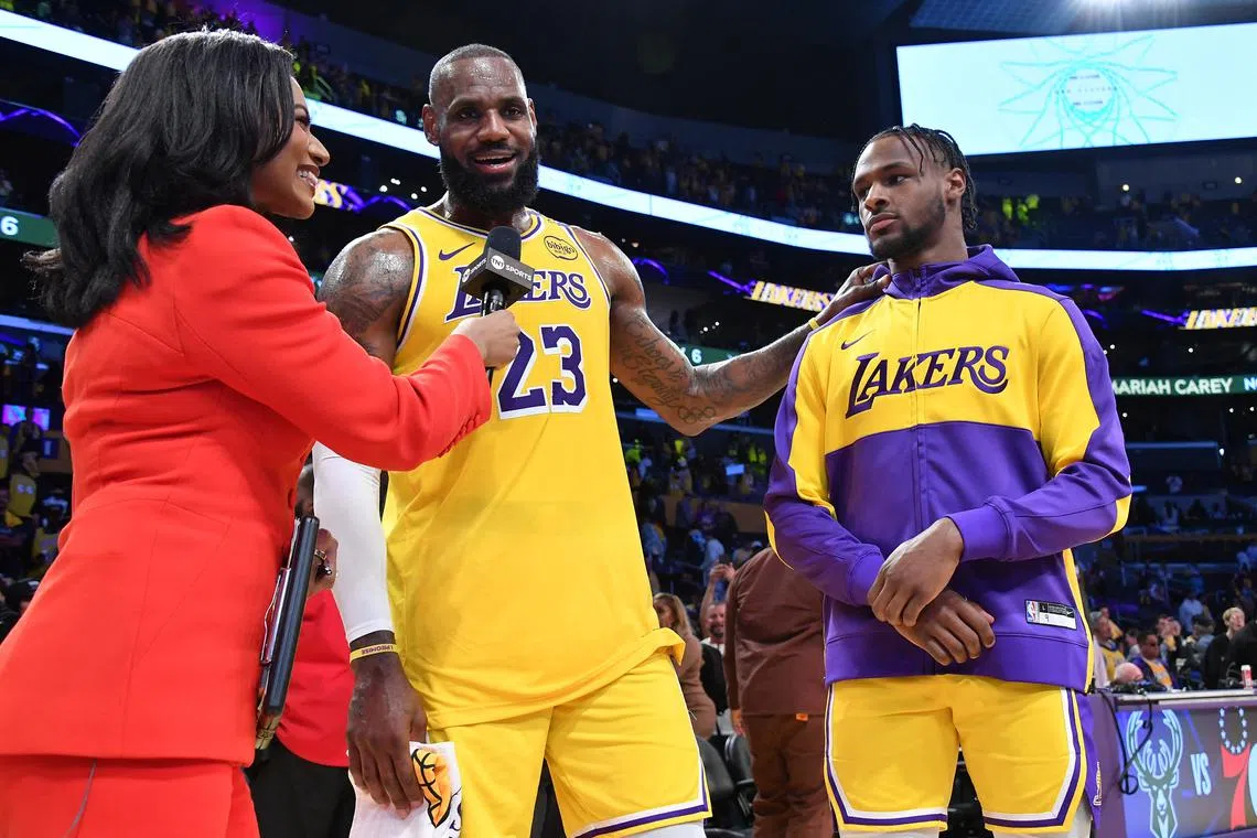 LeBron and Bronny James of the Los Angeles Lakers are interviewed after the game against the Minnesota Timberwolves.