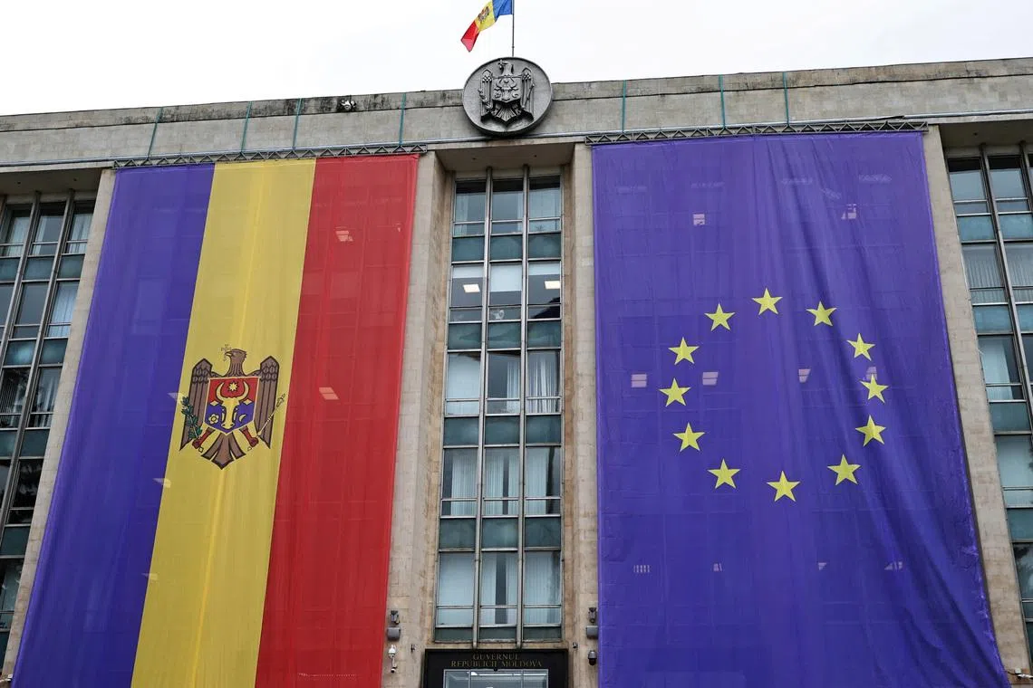 FILE PHOTO: Flags of Moldova and the European Union are displayed on the Government House in Chisinau, Moldova September 4, 2024. REUTERS/Vladislav Culiomza/File Photo