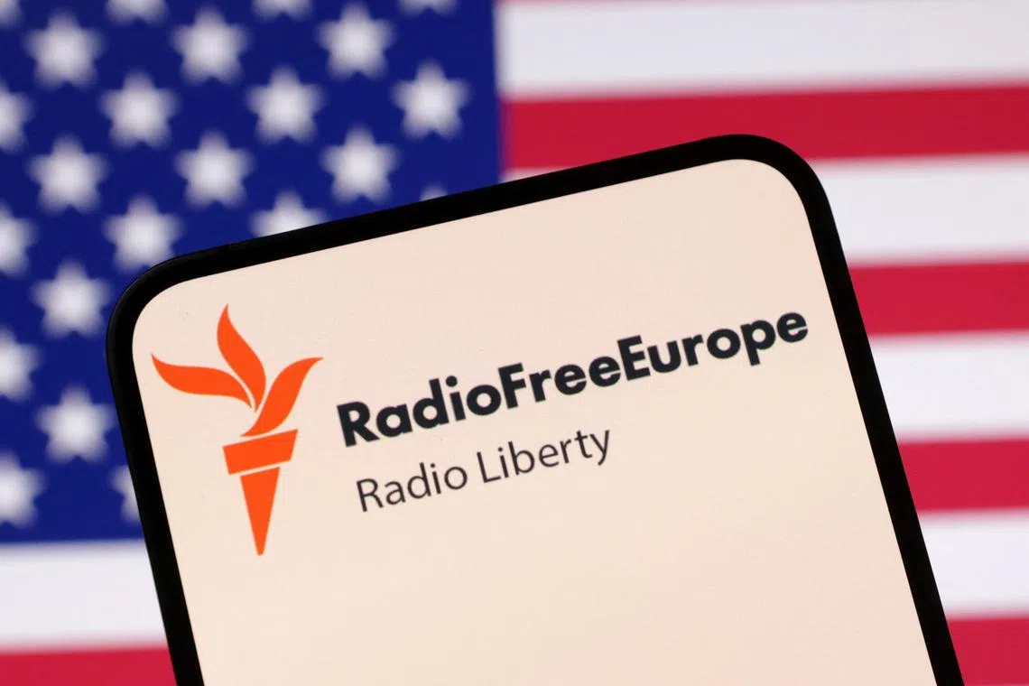 FILE PHOTO: Radio Free Europe logo and U.S. flag are seen in this illustration taken April 23, 2025. REUTERS/Dado Ruvic/Illustration/ File Photo