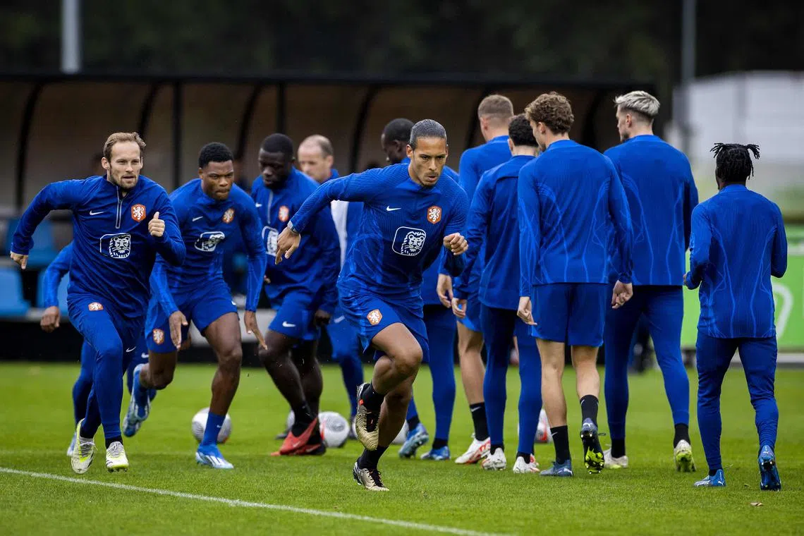 (From left) Netherlands' Daley Blind, Denzel Dumfries and  Virgil van Dijk run during a training session on Thursday.