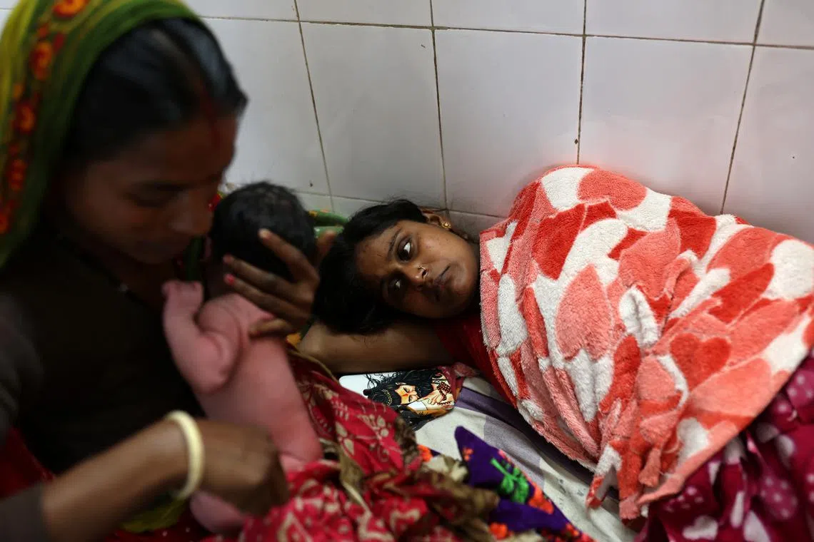Chandani Devi, 36, resting as her mother, Ranjana Devi, holds her newborn daughter at a hospital in the Kishanganj district on March 20. "For the fourth time I have had a girl, now I will wait for a few years before I try to have a boy," said Chandani Devi, 36, as she tried to fight back tears in a hospital ward after her delivery. 