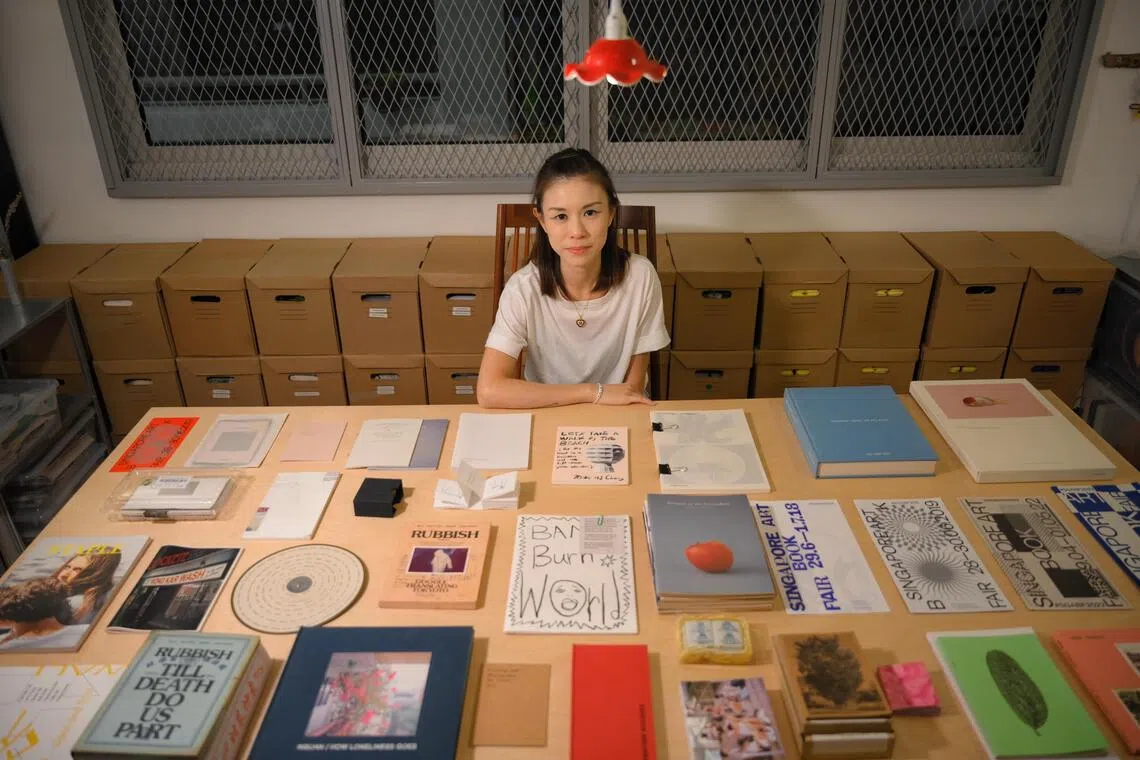 Singapore Art Book Fair founder Renee Ting pictured with some zines and books from the fair over the years. SGABF returns from Oct 31 to Nov 2.