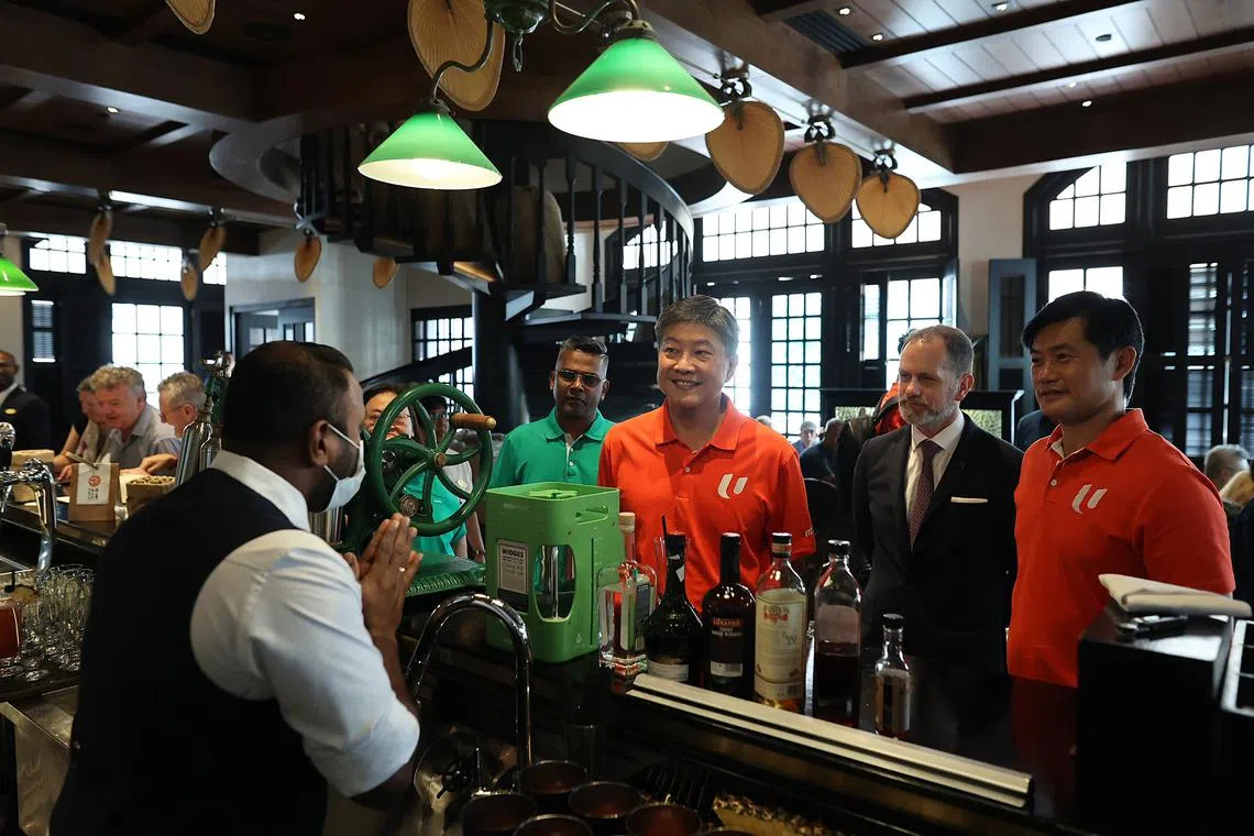 NTUC Secretary-General Ng Chee Meng (centre) and NTUC Deputy Secretary-General Desmond Tan (right) at the Long Bar, Raffles Hotel Singapore on Nov 6. 