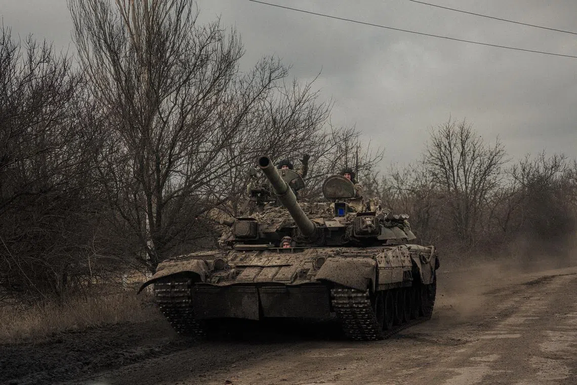 Ukrainian soldiers riding a tank heading toward the front line near Bakhmut, Ukraine, on March 5, 2023. 