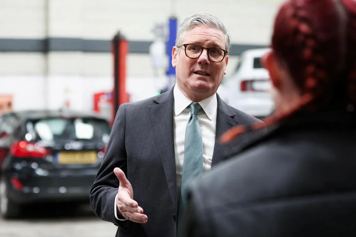 Britain's Prime Minister Keir Starmer visits a local mechanics business, following the British government's announcement of investments to maintain roads across the UK, in Cambridge, Cambridgeshire, Britain, March 24, 2025. REUTERS/Chris Radburn/File Photo