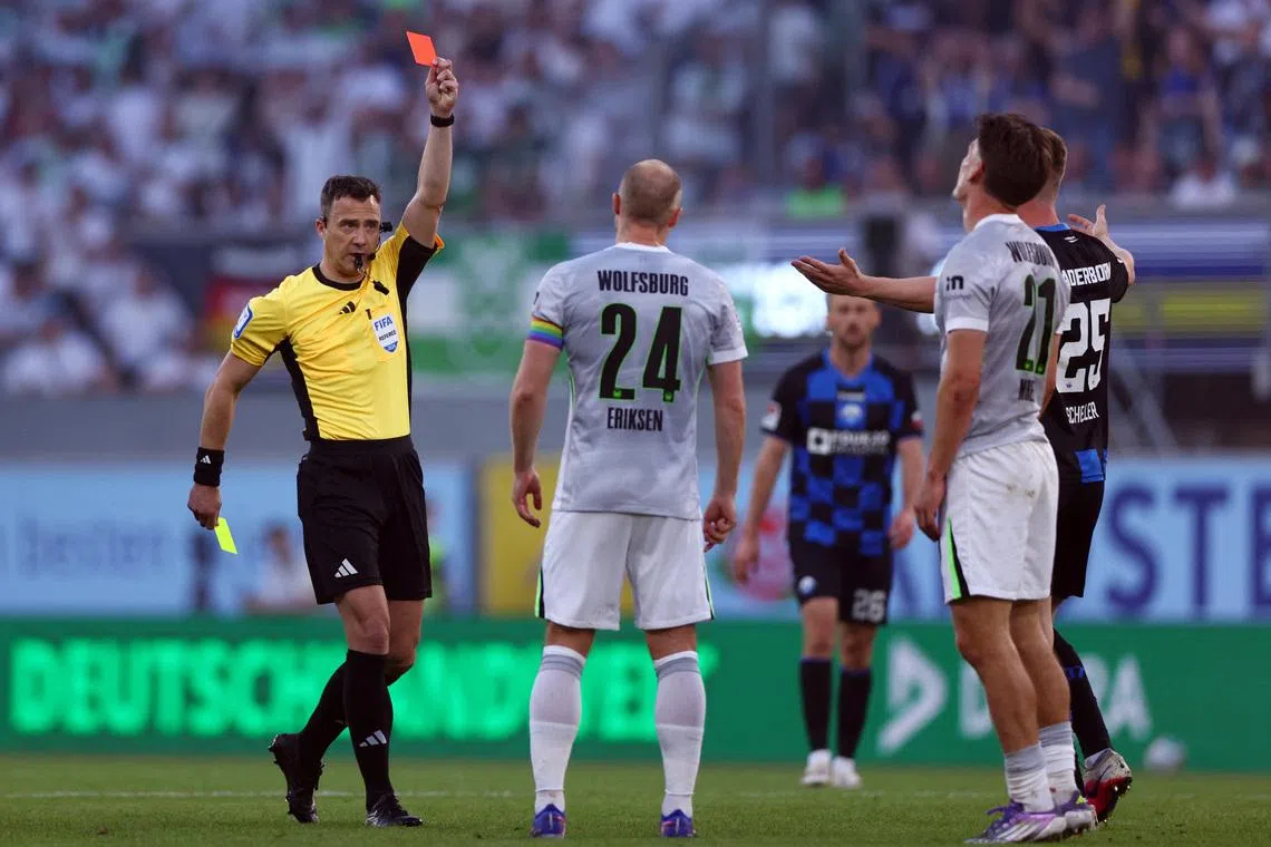 Soccer Football - Bundesliga - Relegation Playoff - Second Leg - SC Paderborn v VfL Wolfsburg - Home Deluxe Arena, Paderborn, Germany - May 25, 2026 VfL Wolfsburg's Joakim Maehle is shown a red card by referee REUTERS/Thilo Schmuelgen