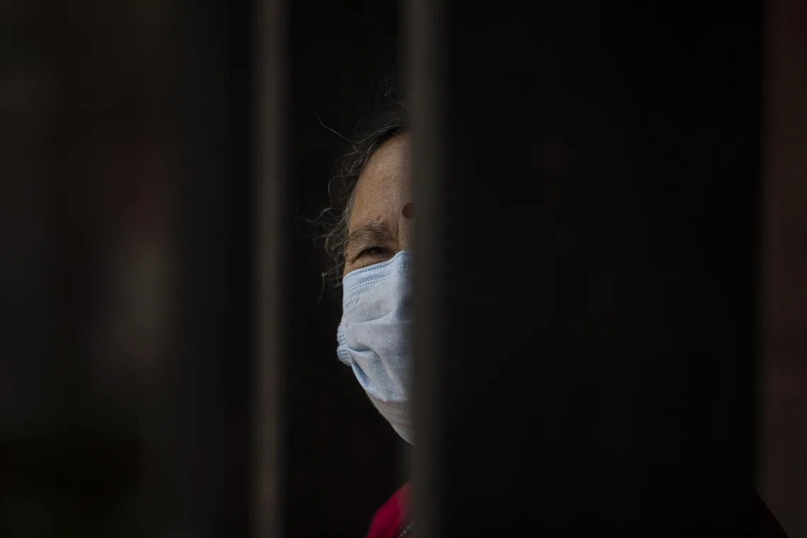 An elderly woman looks on after receiving a dose of the Covid-19 vaccine at the Kathmandu Durbar Square in Kathmandu, Nepal, on Aug 10, 2021.