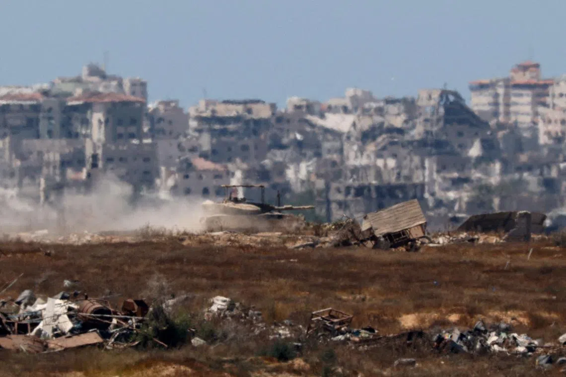 FILE PHOTO: An Israeli tank manoeuvres inside the Gaza Strip, amid the ongoing conflict between Israel and Hamas, as seen from Israel, June 17, 2024. REUTERS/Amir Cohen/File Photo
