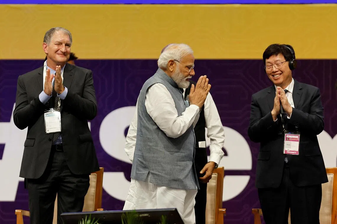 (From left) AMD chief technology officer Mark Papermaster,  Indian PM Narendra Modi and Foxconn Chairman Young Liu, at the SemiconIndia 2023, on July 28.