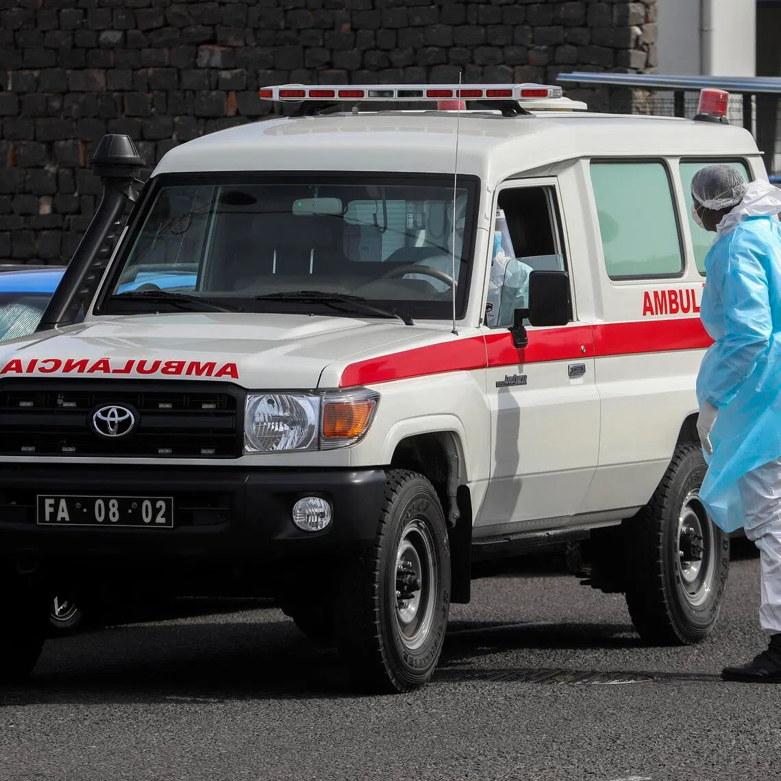 An ambulance carrying one of the three passengers suspected of having hantavirus on the cruise ship MV Hondius, leaves the port in Praia, Cape Verde, on May 6.