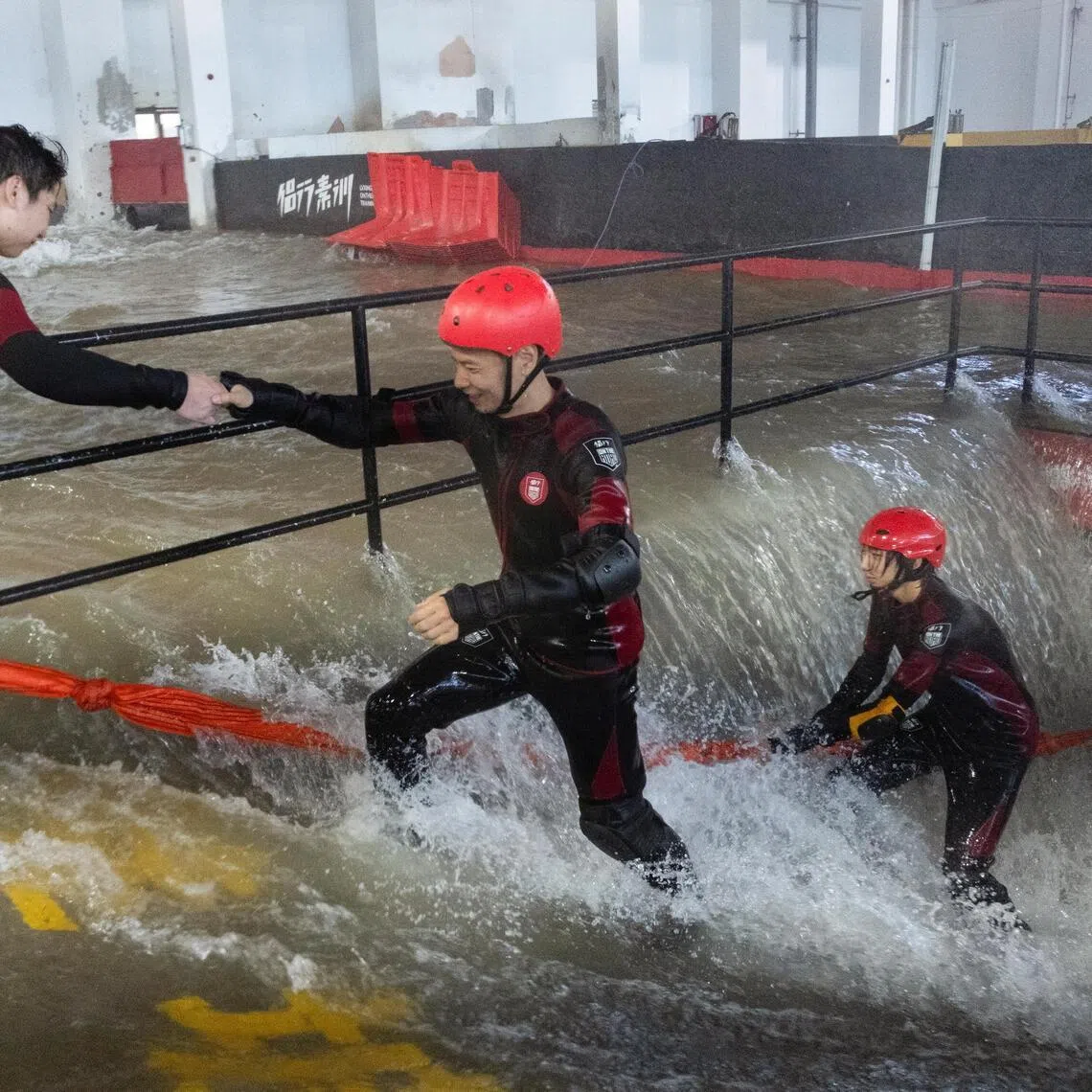 Participants practice evacuating an underground facility during a typhoon survival training session at the Lvxing Disaster Simulation Training Centre.