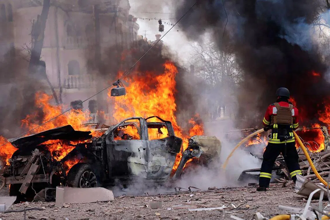 A Ukrainian rescuer works to extinguish a fire at the site of a missile attack in Sumy, northeastern Ukraine, on April 13.
