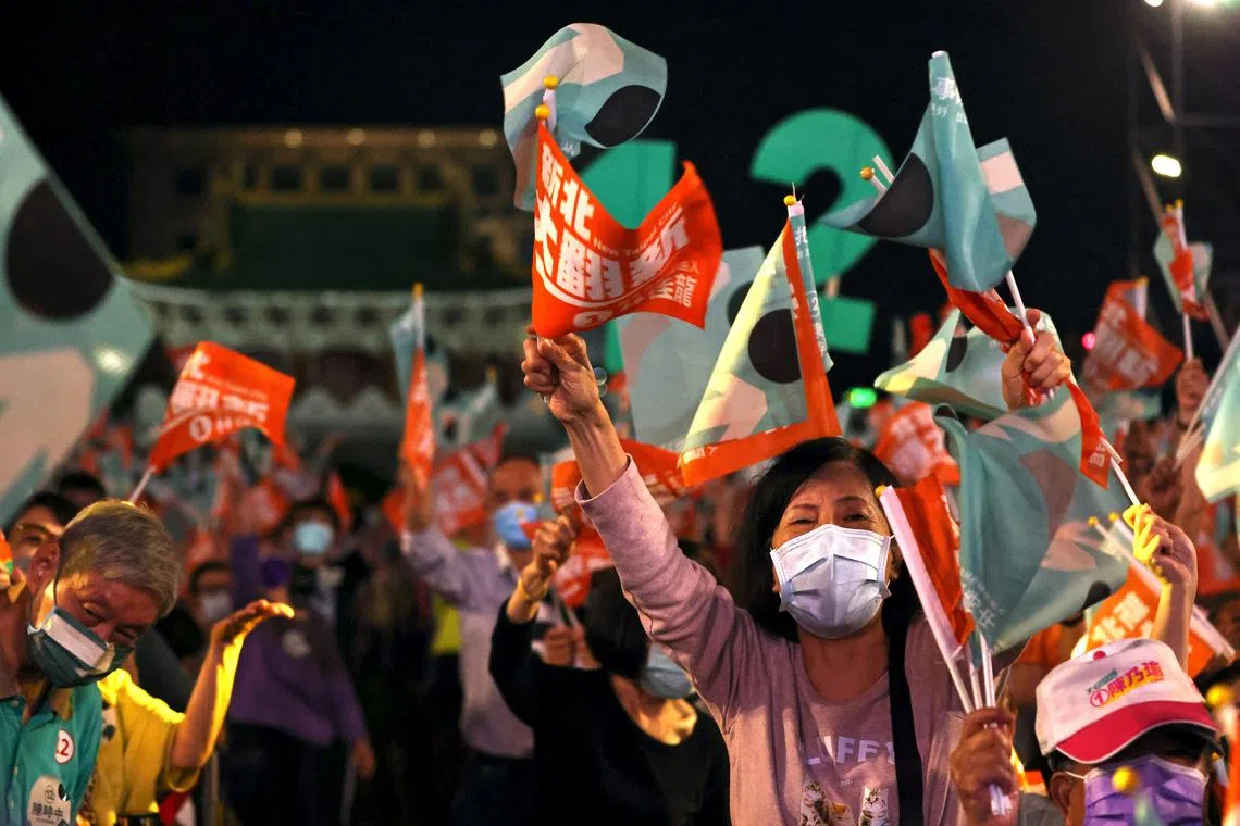 People wave flags at the Taiwan's ruling Democratic Progressive Party pre-election campaign ahead of elections in Taipei.