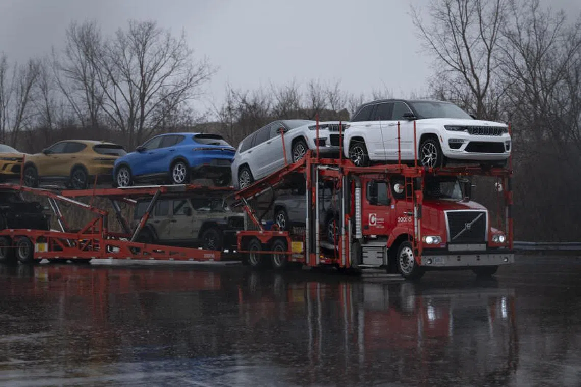 A truck transports finished vehicles from the Stellantis plant in Windsor, Canada, Jan. 31, 2025. President Trump’s new tariffs on goods from Canada, Mexico and China are likely to result in higher prices for lots of products, including computers, tequila and gas. (Ian Willms/The New York Times)