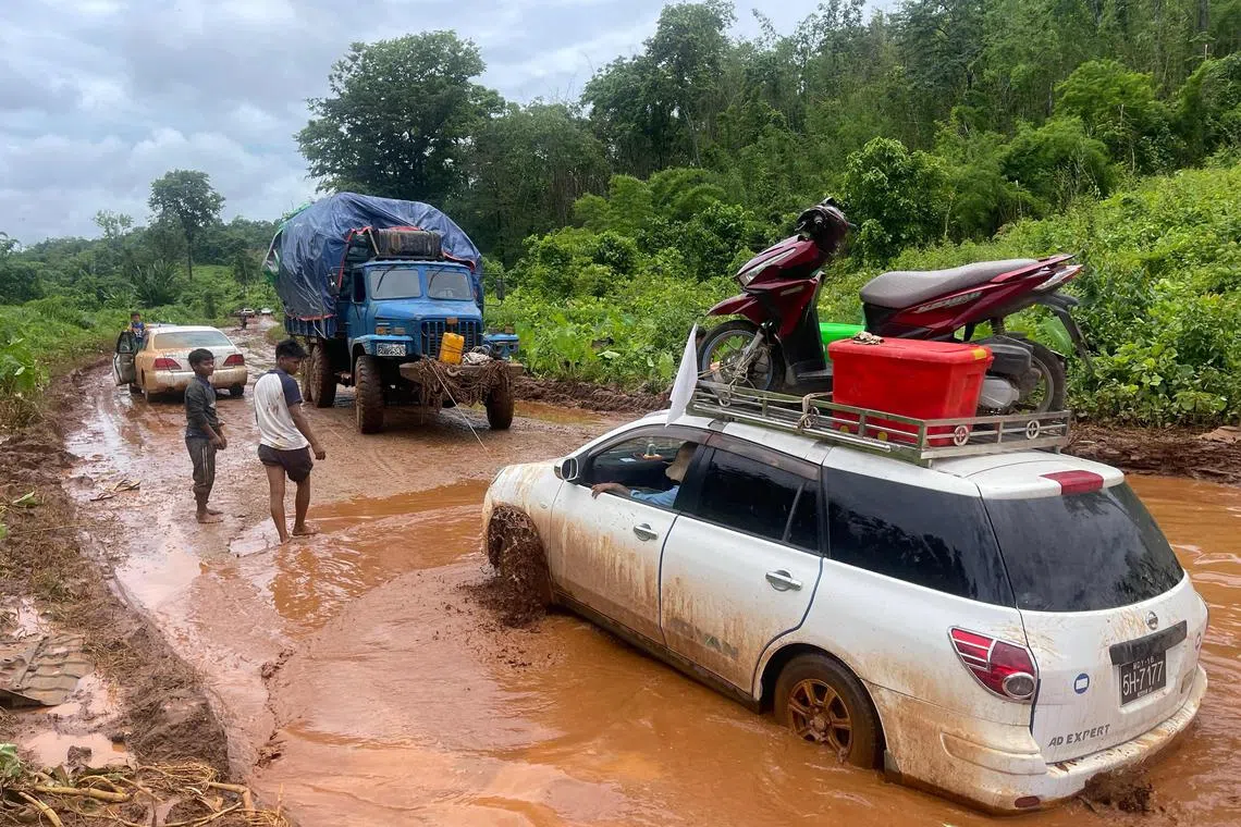 Displaced people from Lashio  trying to cross a flooded area as they flee their homes following clashes between Myanmar's military and the Ta'ang National Liberation Army (TNLA).