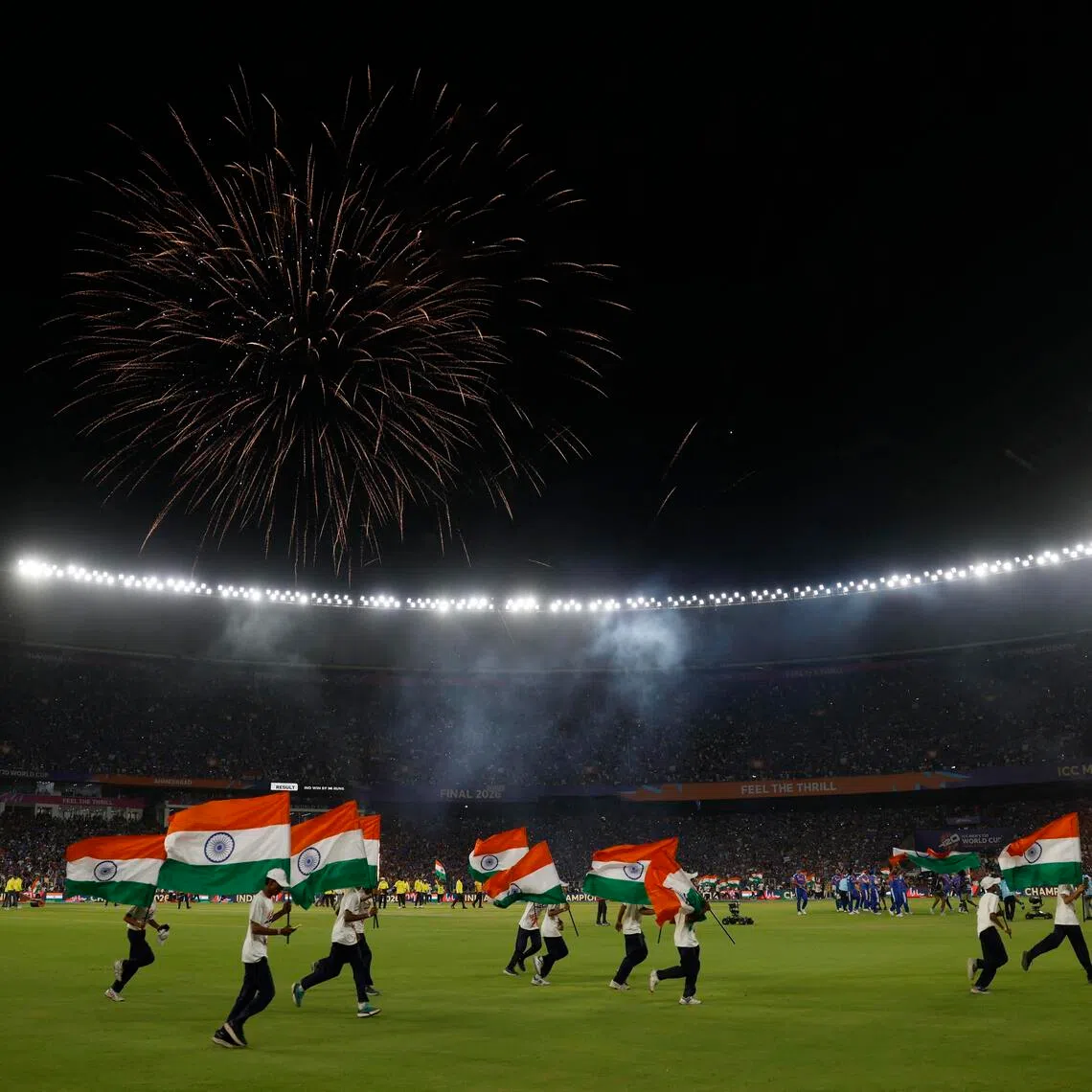 India flags are displayed on the Narendra Modi Stadium pitch as fans celebrate after the team won the cricket Men's T20 World Cup against New Zealand in Ahmedabad on March 8, 2026.