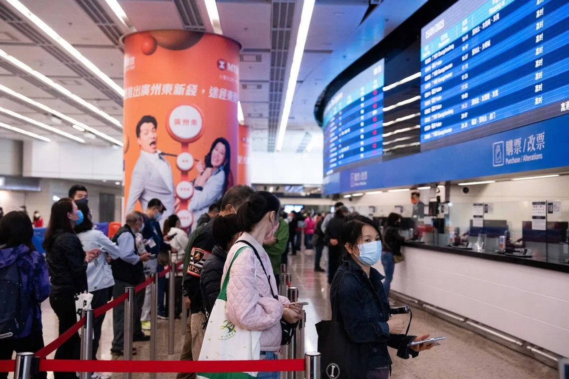 Travellers queue to purchase tickets inside the departure hall at West Kowloon Station, operated by MTR, in Hong Kong, China, on Sunday, Jan 15, 2023. 