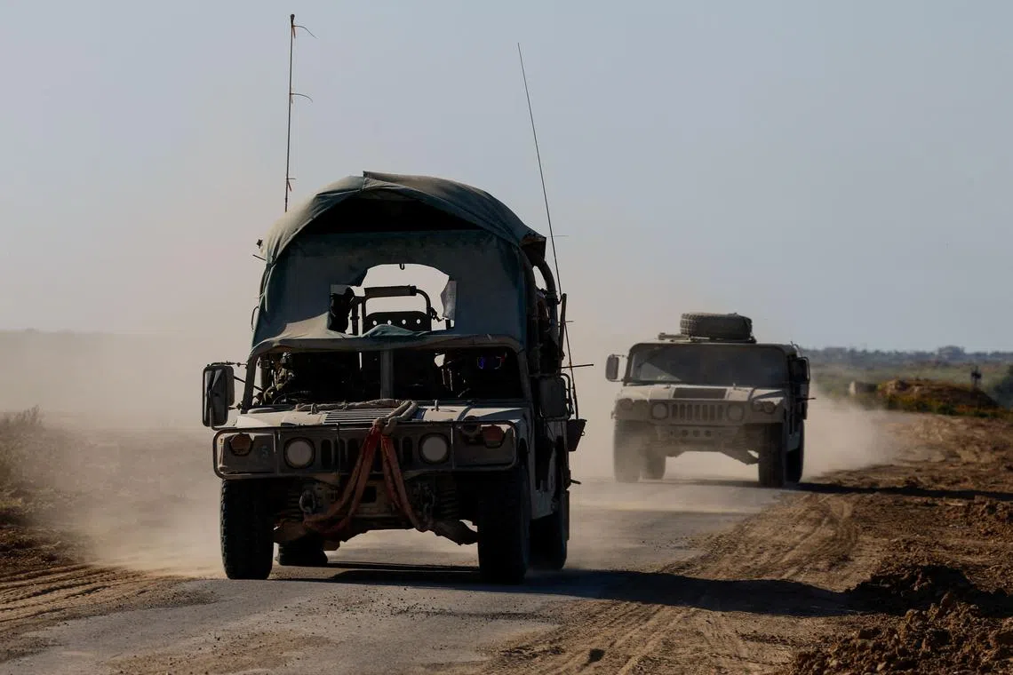 Israeli military vehicles manoeuvre near the Israel-Gaza border, amid the ongoing conflict between Israel and the Palestinian group Hamas, in Israel, March 5, 2024. REUTERS/Amir Cohen