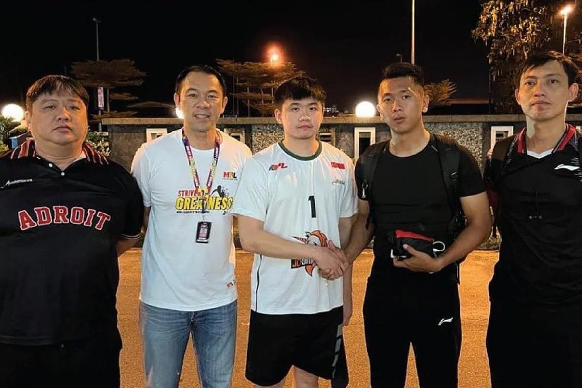 Singapore Adroit guard Poh Wei Hao (in white) shaking hands with referee Joeseph Ho after punching him in a Major Basketball League game.