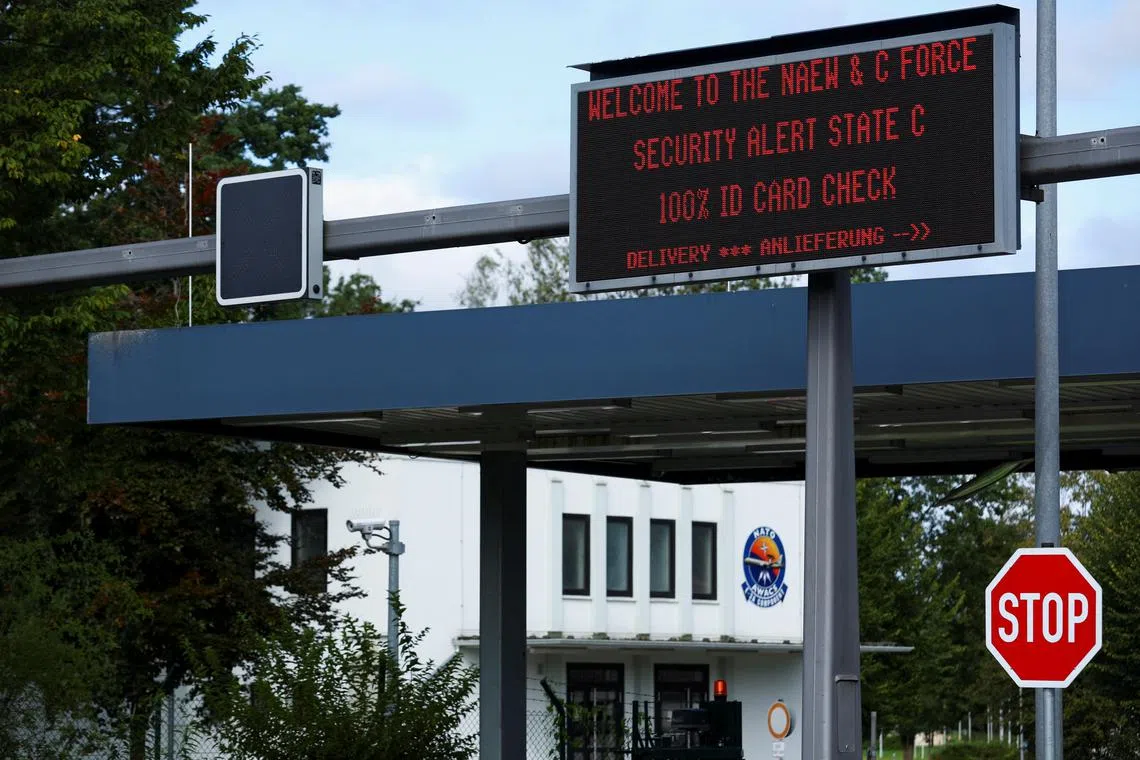 FILE PHOTO: A screen displays a message in front of the main gate after the NATO air base in the German town of Geilenkirchen has raised its security level \"based on intelligence information indicating a potential threat,\" in Geilenkirchen, Germany August 23, 2024. REUTERS/Thilo Schmuelgen/File Photo
