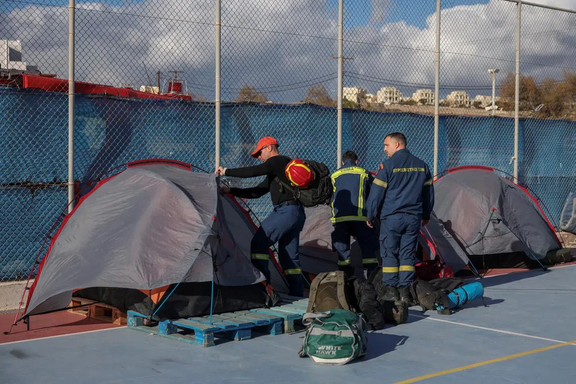 FILE PHOTO: Firefighters arrange their gear in their tents, at the temporary headquarters of emergency services, as the increased seismic activity continues on the island of Santorini, Greece, February 7, 2025. REUTERS/Louisa Gouliamaki/File Photo