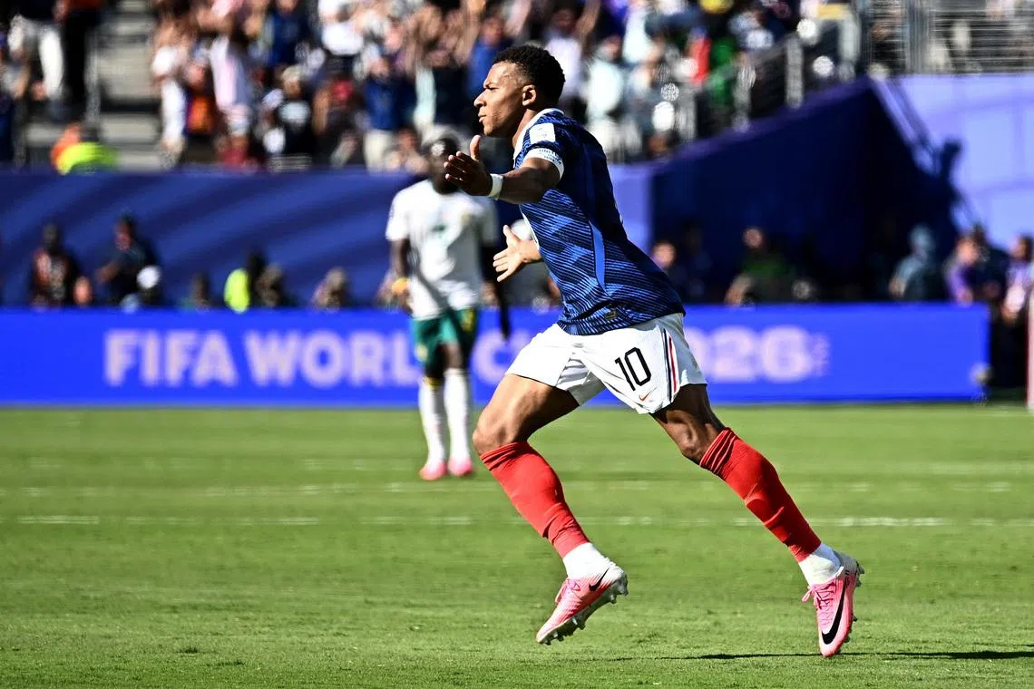 France's Kylian Mbappe celebrates scoring their third goal against Senegal on June 16. 