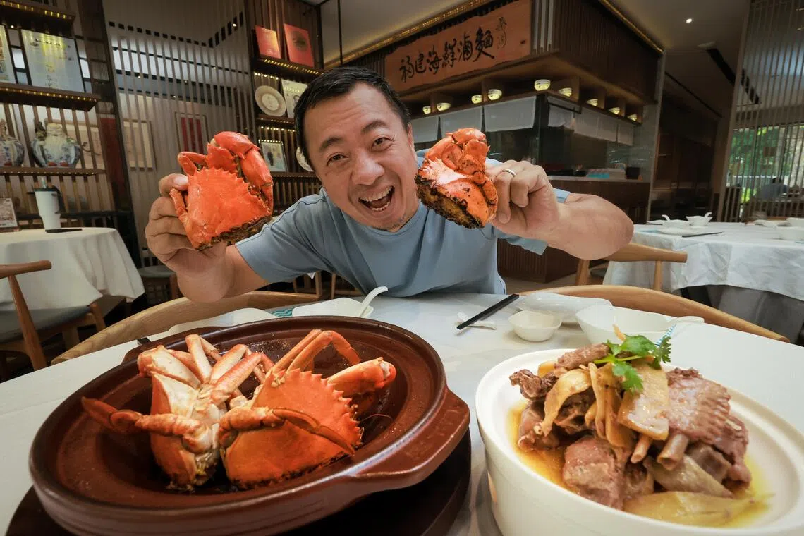 Putien founder Fong Chi Chung with two new dishes, Tong’an Pan-fried Crab and Di Lu Muscovy Duck in Natural Essence, at the restaurant’s Kitchener Road outlet.
