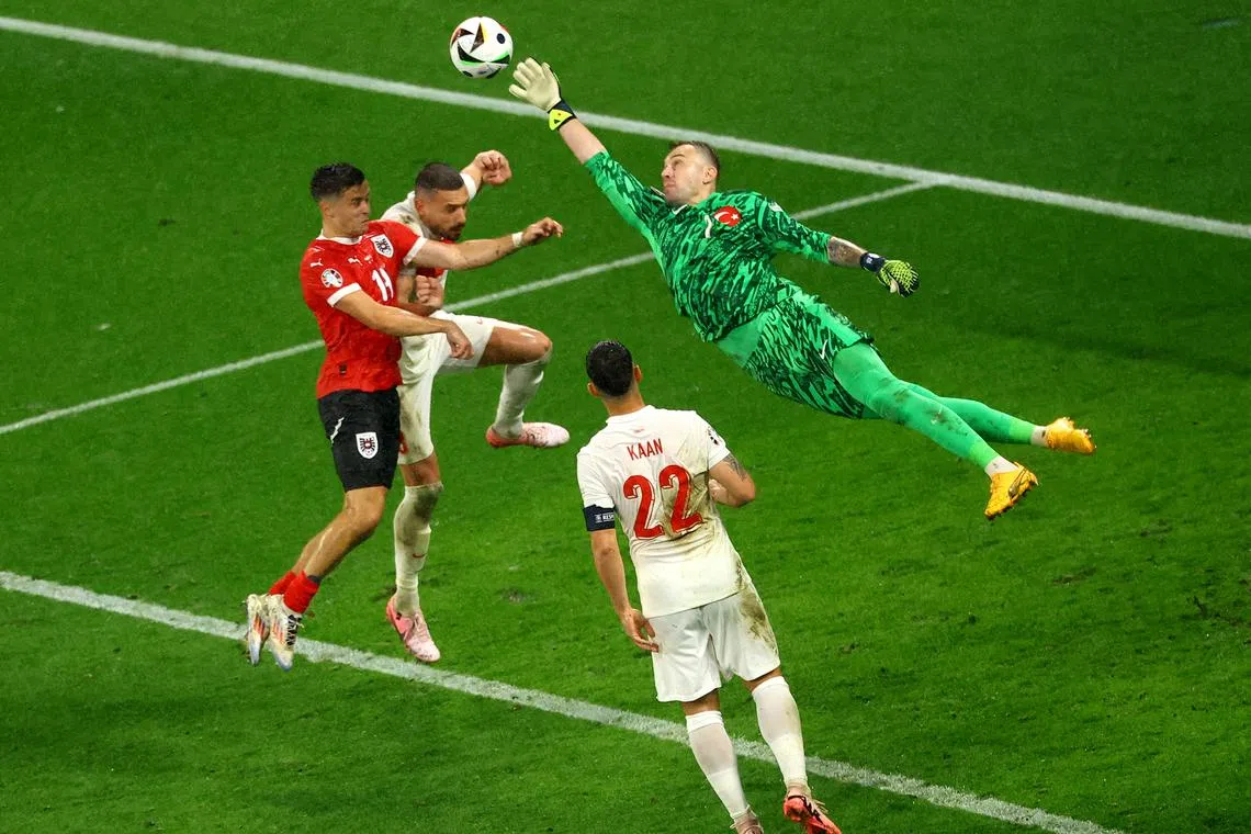 Soccer Football - Euro 2024 - Round of 16 - Austria v Turkey - Leipzig Stadium, Leipzig, Germany - July 2, 2024 Turkey's Mert Gunok makes a save from Austria's Christoph Baumgartner REUTERS/Lisi Niesner