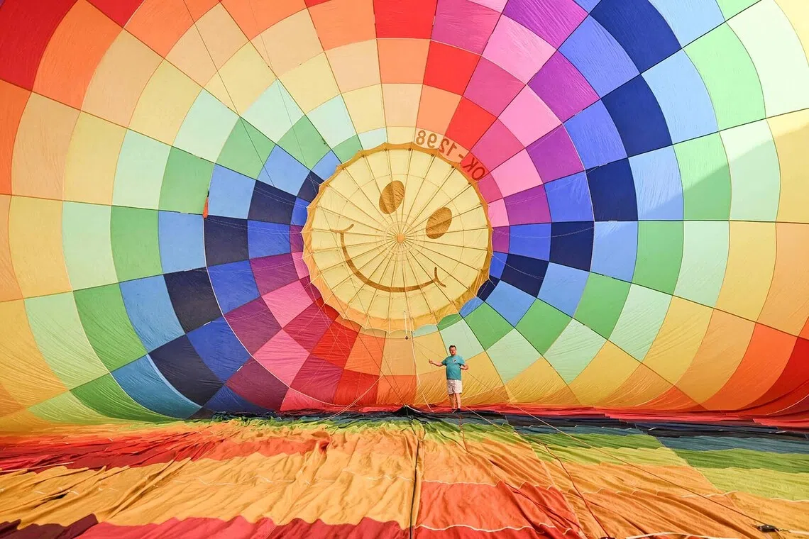 TOPSHOT - A man prepares hot-air balloon prior to the hot air balloon Fiesta on September 2, 2026 in Hradec Kralove city, Czech Republic. (Photo by Michal Cizek / AFP)