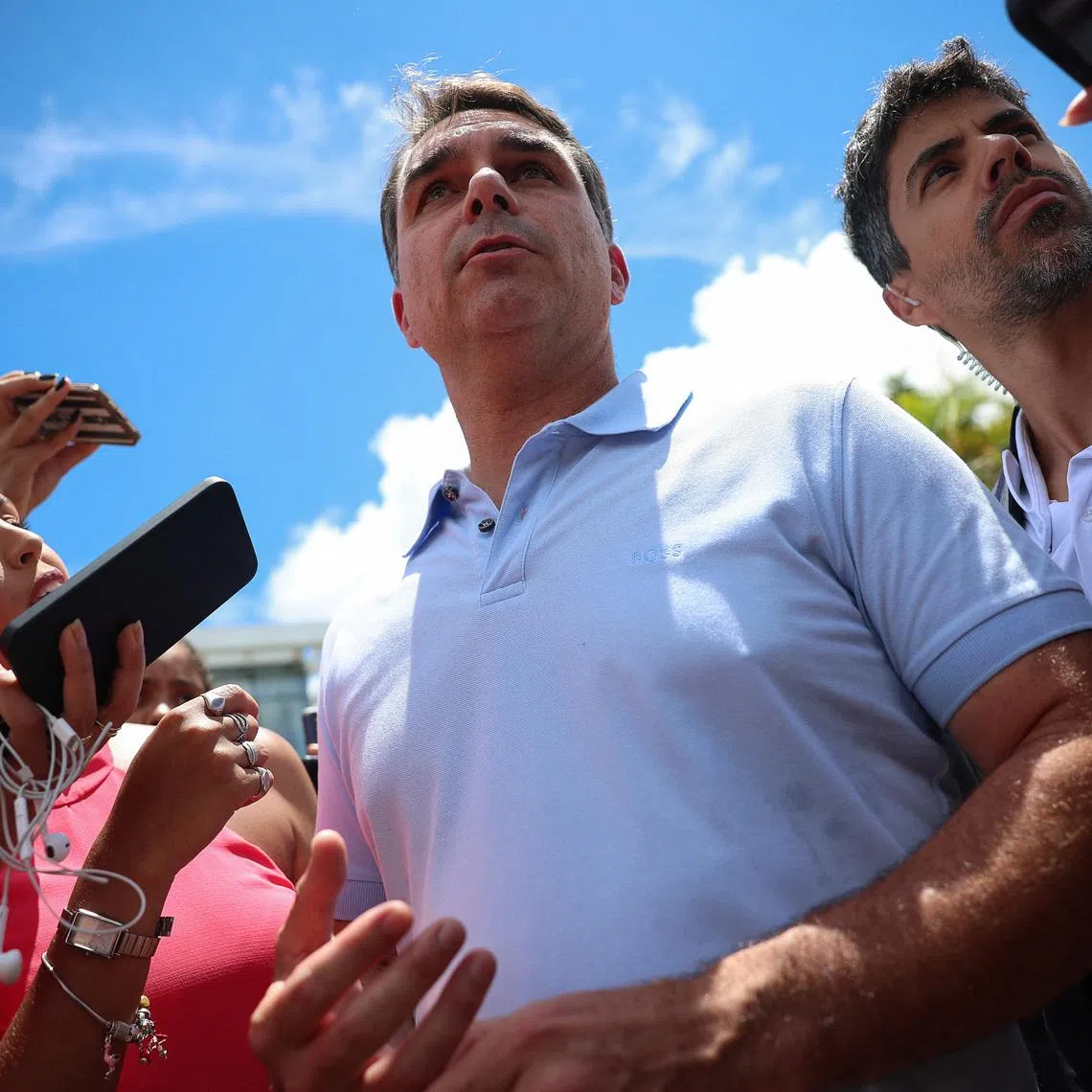 Senator Flavio Bolsonaro attends a press conference outside a hospital, as his father, Brazil's former President Jair Bolsonaro is hospitalized, while serving a 27-year sentence for plotting a coup against his successor, President Luiz Inacio Lula da Silva, in Brasilia, Brazil, March 13, 2026. REUTERS/Adriano Machado