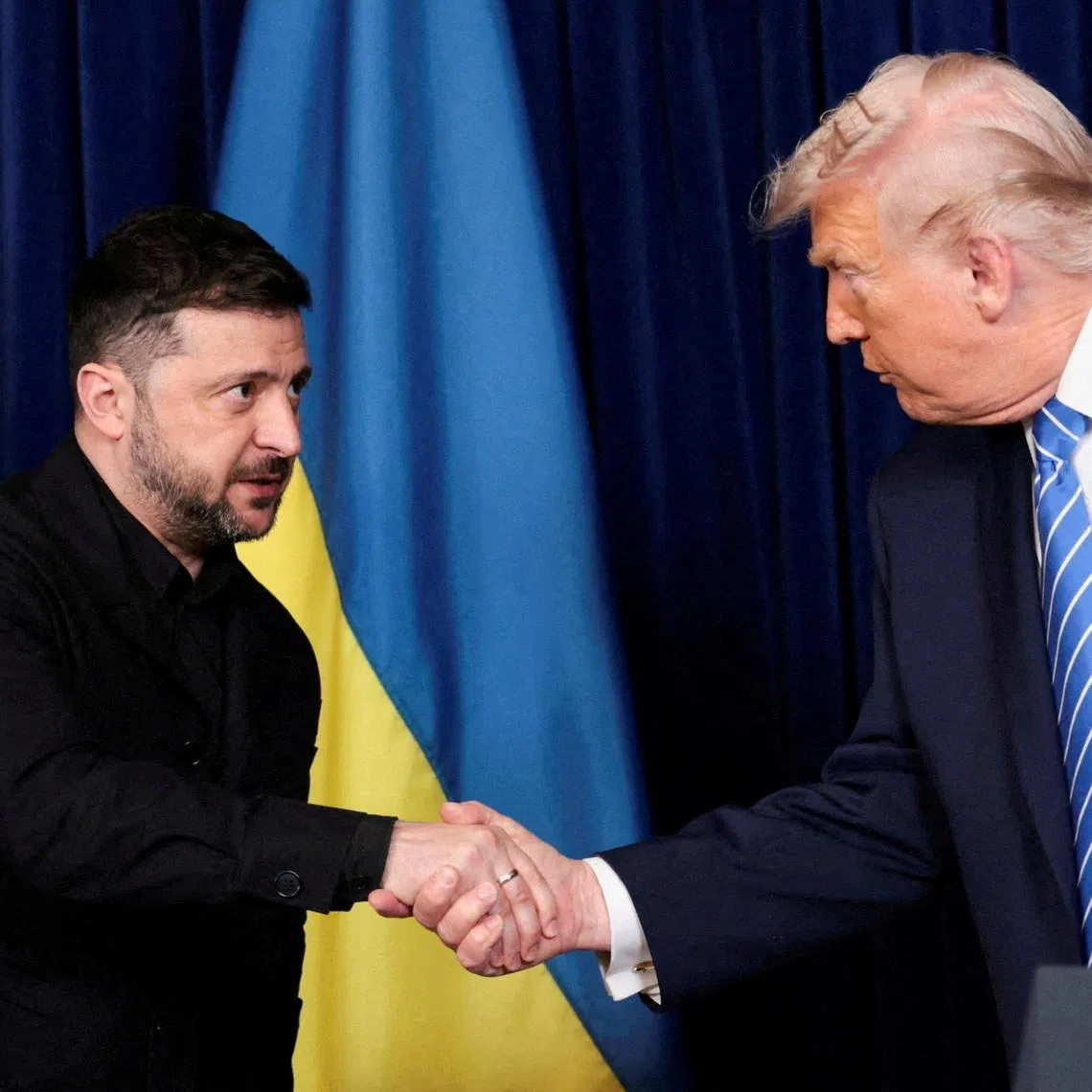 FILE PHOTO: U.S. President Donald Trump and Ukrainian President Volodymyr Zelenskiy shake hands during a press conference after their lunch meeting at Trump’s Mar-a-Lago club, in Palm Beach, Florida, U.S., December 28, 2025. REUTERS/Jonathan Ernst/File Photo