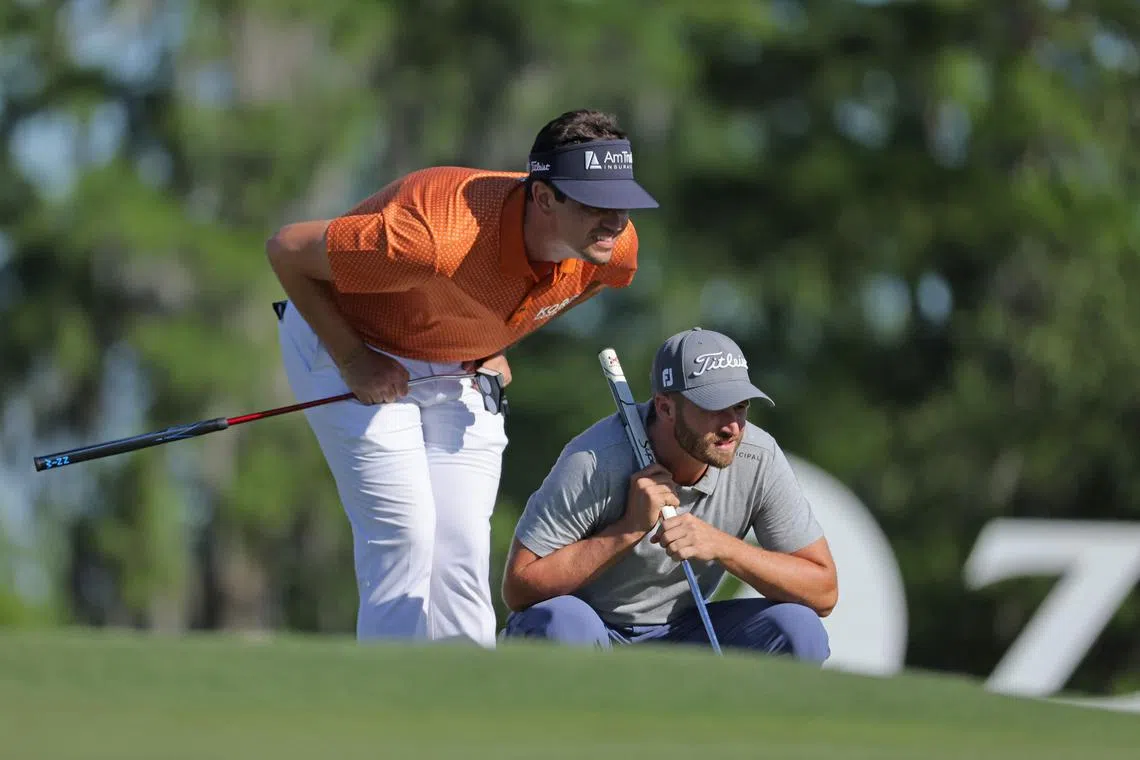 Beau Hossler and Wyndham Clark of the United States preparing to putt on the 17th green during the third round of the Zurich Classic of New Orleans at TPC Louisiana on Saturday. The leaders combined for a 10-under 62 on Saturday to get to 26 under for the tournament.