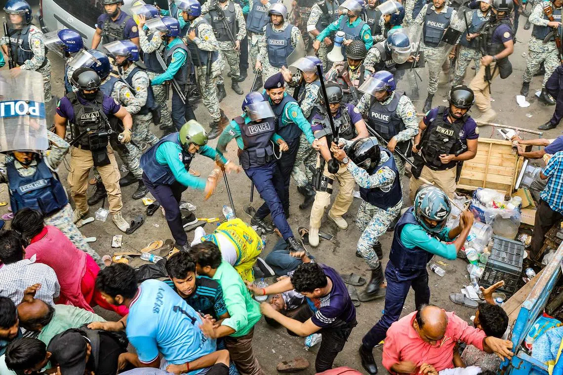 Police baton-charge protesting supporters of Chinmoy Krishna Das Brahmachari, a jailed Hindu monk leader and member of the Bangladesh Sammilito Sanatan Jagaran Jote group, during a demonstration after court denied his bail in Chittagong on Nov 26, 2024. 